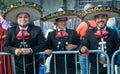 Three Mexican mariachi in costumes and hats