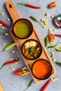Three mexican sauces on wooden board with vegetables on gray background