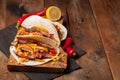 Three Mexican tacos with marbled beef, black Angus and vegetables on old rustic table. Mexican dish with sauces guacamole and sals Royalty Free Stock Photo