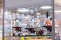 Three microscopes in glass showcase at science exhibition - laboratory equipment