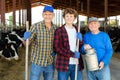 Three milk farm workers in cowhouse Royalty Free Stock Photo