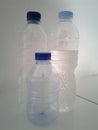 Three mineral water bottles on the white floor Royalty Free Stock Photo