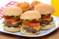 Three Mini Cheeseburger Sliders with Onion Rings Royalty Free Stock Photo