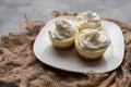 Three mini Cheesecakes with whipped cream icing on a white plate Royalty Free Stock Photo