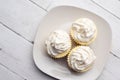 Three mini Cheesecakes with whipped cream icing on a white plate Royalty Free Stock Photo