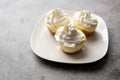 Three mini Cheesecakes with whipped cream icing on a white plate Royalty Free Stock Photo