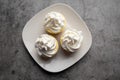 Three mini Cheesecakes with whipped cream icing on a white plate Royalty Free Stock Photo