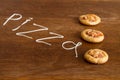 Three mini pizzas with sausage and cheese on wood table Royalty Free Stock Photo