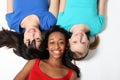 Three mixed race teenage girl friends on floor Royalty Free Stock Photo