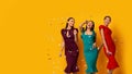 Three Models Posing Under Falling Silver Confetti, Yellow Background, Panorama Royalty Free Stock Photo