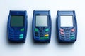 Three modern credit card terminals in navy blue, featuring colorful buttons, ready for transactions Royalty Free Stock Photo