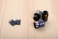 Three modern flash drives for a digital camera lie on a wooden table opposite three old 35 mm film Royalty Free Stock Photo