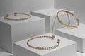 Three modern Golden bracelets on white geometric white blocks Royalty Free Stock Photo