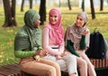 Three Modern Islamic Female Students Spending Time Chatting Outdoors