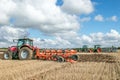 Three Modern tractors pulling ploughs Royalty Free Stock Photo