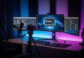 Three monitors display programming and live streaming applications on a desk setup illuminated with Royalty Free Stock Photo