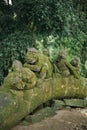 three monkey statues playing in a forest Royalty Free Stock Photo