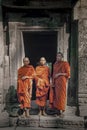 Three Monks at the ancient ruins of Cambodia`s Angkor Wat temple complex