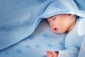 Three month old baby sleeping on blue blanket Royalty Free Stock Photo