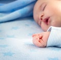 Three month old baby sleeping on blue blanket Royalty Free Stock Photo