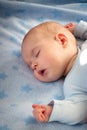 Three month old baby sleeping on blue blanket Royalty Free Stock Photo
