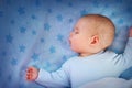 Three month old baby sleeping on blue blanket Royalty Free Stock Photo