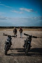 three motorcycles are parked in the middle of a desert field Royalty Free Stock Photo