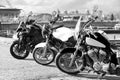 Three motorcycles standing in line, black and white image