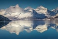 Three mountain peaks covered with snow by the northern Norway fjord