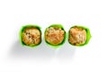 Three Muffins or Cupcakes in Green Paper Isolated