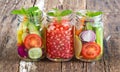 Three mug delicious refreshing drink of mix fruits and herb on wooden background Royalty Free Stock Photo