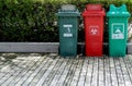 A three multi bins on wooden floor in garden, environment concepts