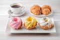 Three multi-colored cupcakes on a rectangular plate. Royalty Free Stock Photo