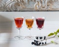 Three multi-colored liquors on vintage white wooden background. ÃÂ¡opy space