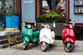 Three multi-colored mopeds in retro style.