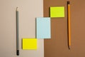 Three multi-colored sticky sticky paper and two pencils Royalty Free Stock Photo