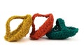 Three multi-colored washcloths woven from jute twine