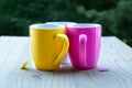 Three multi coloured mugs with tea Royalty Free Stock Photo