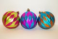 Three multicolored christmas ornaments isolated on a white background Royalty Free Stock Photo