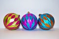 Three multicolored christmas ornaments on a white background Royalty Free Stock Photo