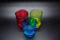 Three multicolored shot glasses on black background