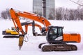 Dance of excavators in the snow