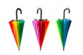 Three multicolored umbrellas on white