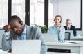 three multiethnic business people in headsets working with laptops Royalty Free Stock Photo