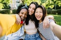 Three multiracial best female friends taking selfie portrait together outdoors Royalty Free Stock Photo