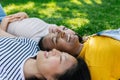 Three multiracial young women friends laughing together outdoors Royalty Free Stock Photo