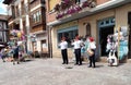 Three musicians wearing traditional clothes are playing typical Spanish instruments