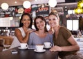 The three musketeers. Three friends sitting together in a restaurant having coffee.