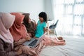 Three muslim women and her daughter using laptop computer for watching information news update Royalty Free Stock Photo