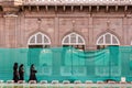 Three muslim women wearing black hijabs walking in the ancient Mecca Masjid mosque Royalty Free Stock Photo